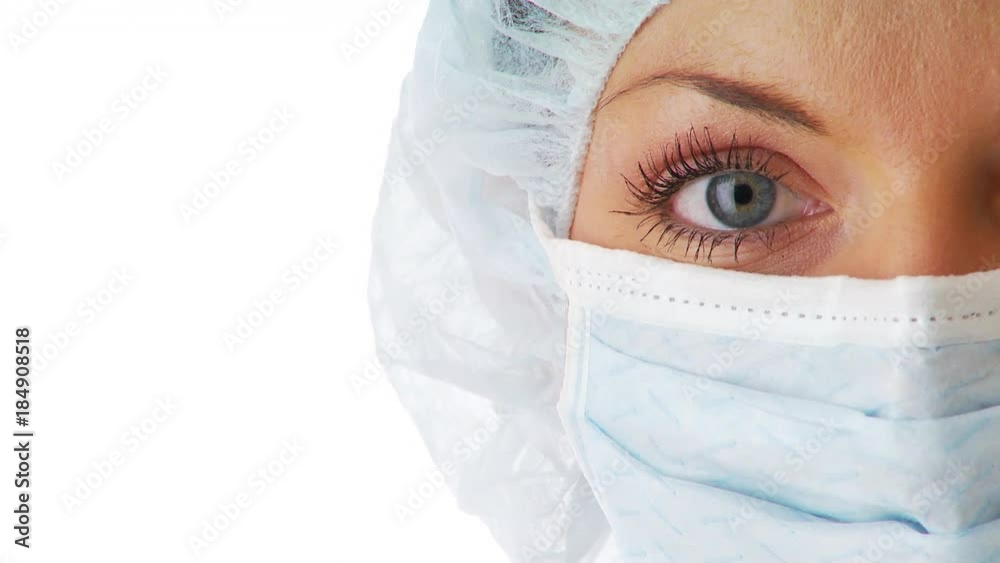 Close up of young woman wearing doctor mask and hair net Close up of young woman wearing doctor mask and hair net
