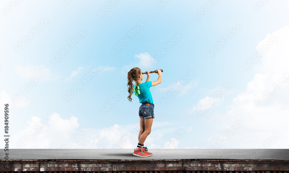 Concept of careless happy childhood with girl exploring this world