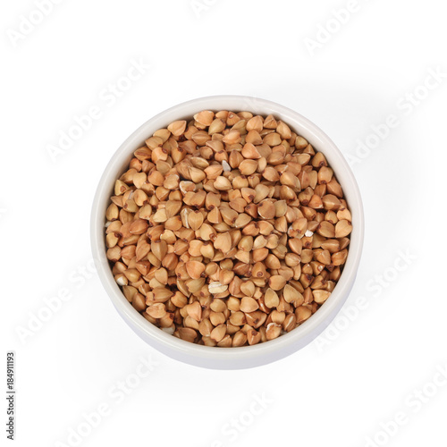 Buckwheat groats in whitebowl isolated on white background