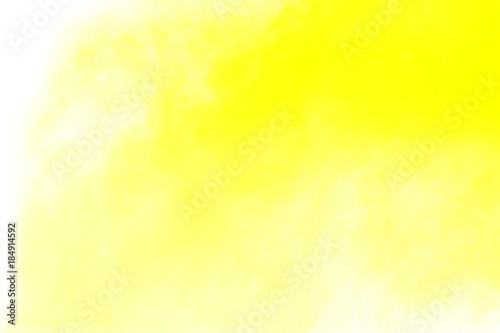 abstract yellow dust explosion on white background. abstract yellow powder splatter on white background. Freeze motion of yellow powder splash.