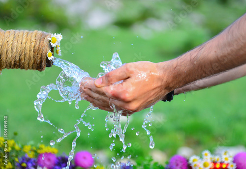 washing hands with water fountain photo