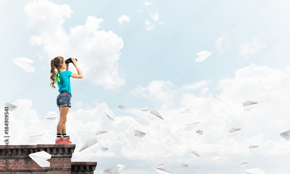 Concept of careless happy childhood with girl of school age looking in future Concept of careless happy childhood with girl of school age looking in future