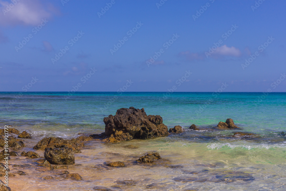 Beach stone . Horizon. Emerald water