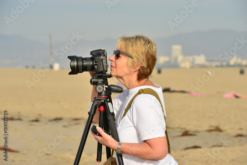 A female photographer at Venice beach in California