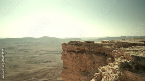 Panning shot of wild negev desert in Israel. Crater mitzpe ramon in wilderness valley. Travel and tourism in middle east