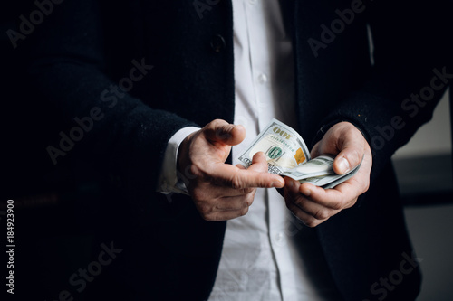  man counting USA Dollar bills