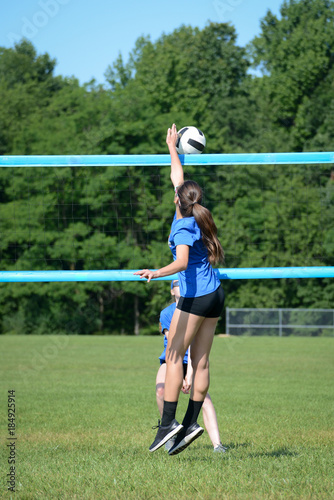 Volleyball player blocking with one hand