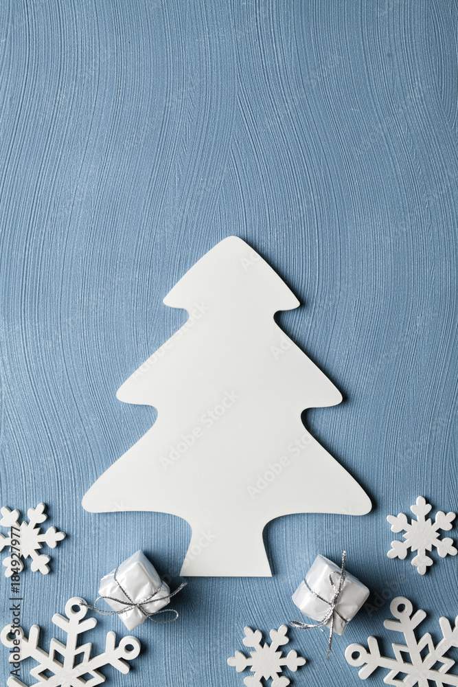 Christmas tree, snowflakes and gifts on blue background Christmas tree, snowflakes and gifts on blue background