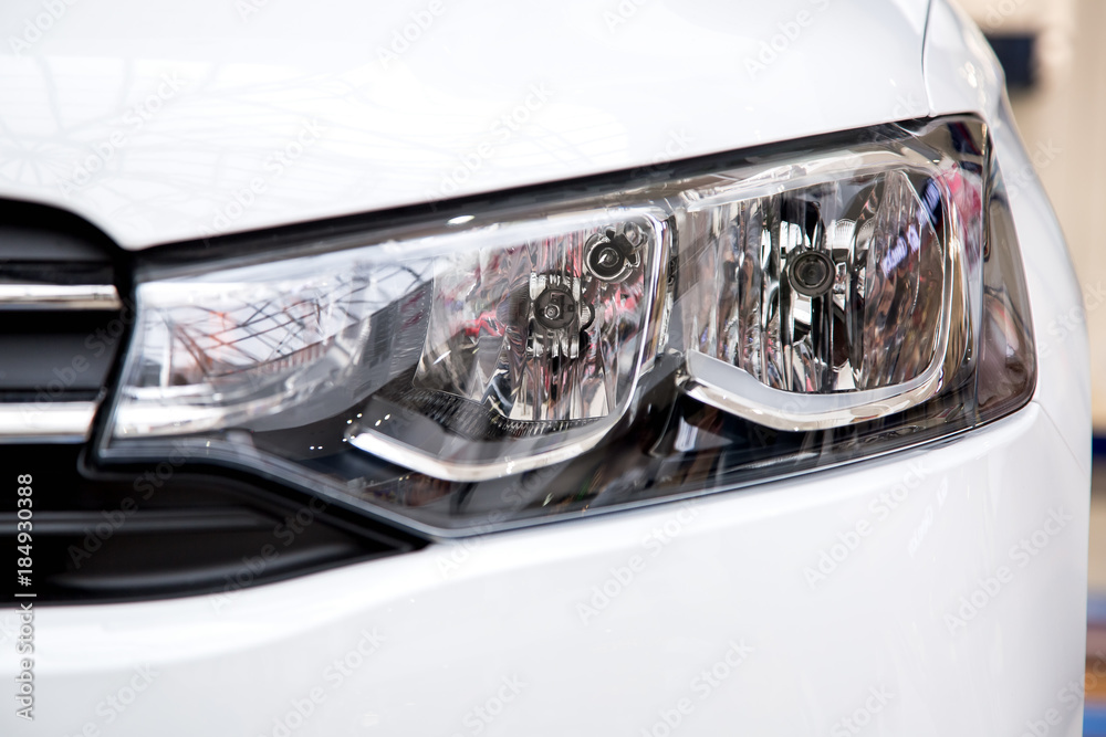Halogen headlight of a white car.