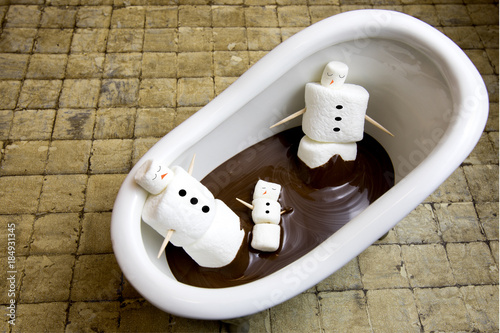 Marshmallow snowman family in chocolate spa photo