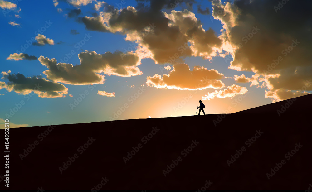 Hiker in silhouette at sunset