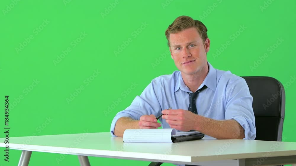 confident businessman sitting at his desk on greenscreen confident businessman sitting at his desk on greenscreen