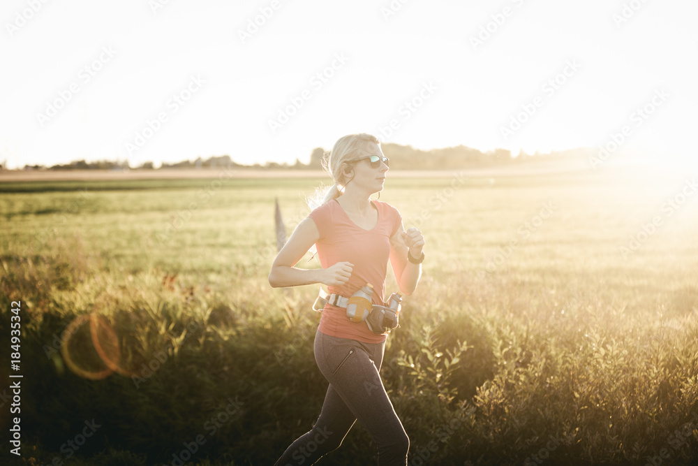 Woman running on rural fields