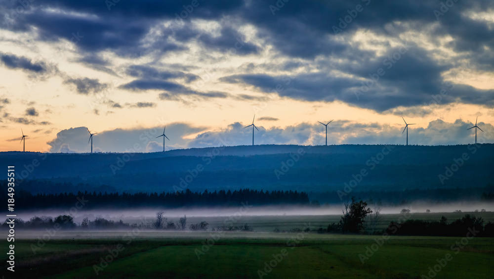 Picturesque view of fields in fog