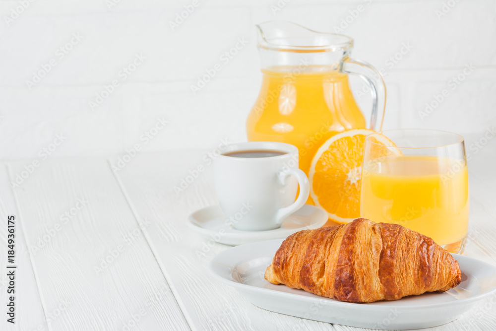 Freshly baked croissant, orange juice, fresh fruits, jam on white wooden background. French breakfast. Fresh pastries for morning. Delicious dessert. Closeup photography. Horizontal banner Freshly baked croissant, orange juice, fresh fruits, jam on white wooden background. French breakfast. Fresh pastries for morning. Delicious dessert. Closeup photography. Horizontal banner