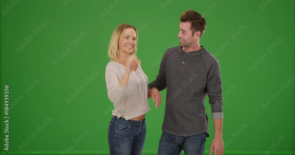 Excited millennial couple buying their first home on green screen. On green screen to be keyed or composited. Excited millennial couple buying their first home on green screen. On green screen to be keyed or composited.