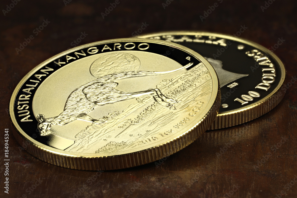 1 ounce Australian Kangaroo gold bullion coins on wooden background 1 ounce Australian Kangaroo gold bullion coins on wooden background