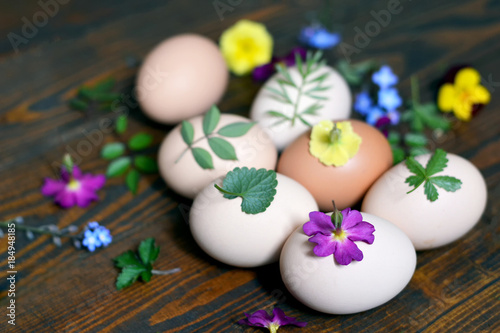 Decorating Easter eggs with leaves and flowers. Easter craft 
