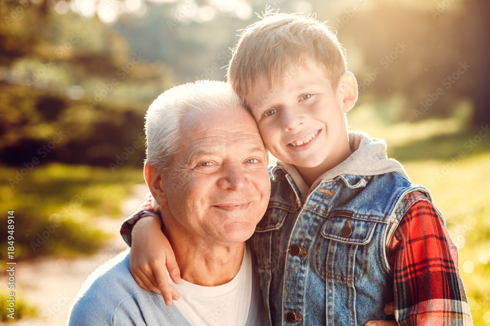 Grandfather and grandson together outdoors family concept