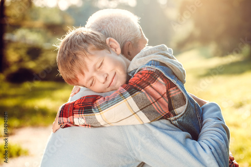 Fotografia Grandfather and grandson together outdoors family concept