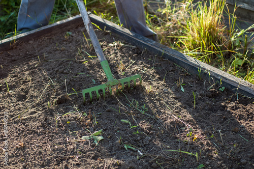 Wallpaper Mural A man works with rakes on the soil. Torontodigital.ca