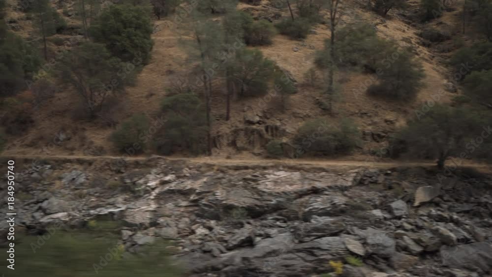 Driving plate side view of merced river from moving car Driving plate side view of merced river from moving car