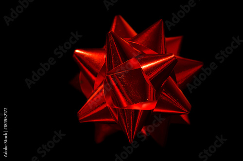 Wallpaper Mural A red cockade used to decorate gift packages during Christmas or the holidays. Photographed in a still life set on a black background Torontodigital.ca