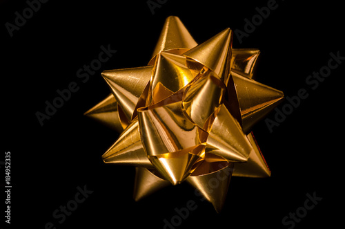Wallpaper Mural A gold cockade used to decorate gift packages during Christmas or the holidays. Photographed in a still life set on a black background Torontodigital.ca