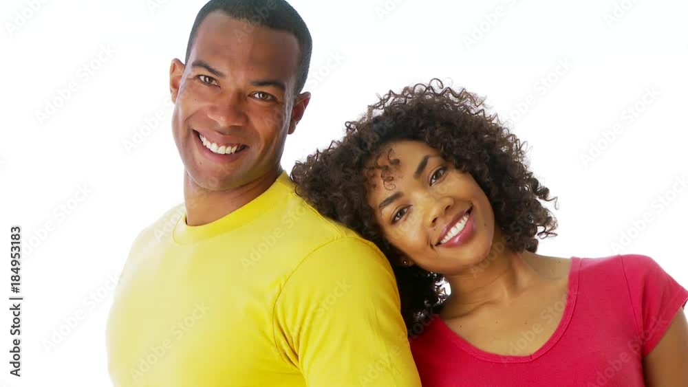 African-American couple standing together smiling and looking at camera African-American couple standing together smiling and looking at camera