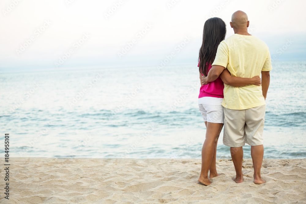 Rear view of a couple on the beach. Rear view of a couple on the beach.