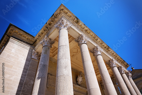 Old roman architecture columns in perspective, against blue sky.