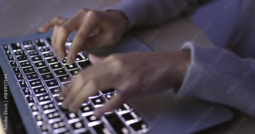 Woman working on laptop computer at night Woman working on laptop computer at night