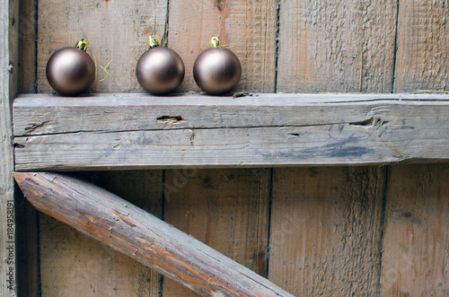 three Christmas balls on old wooden background wall