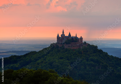 German Castle Burg Hohenzollern over the clouds at sunset landscape photo