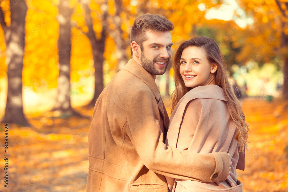 Young couple walk in the autumn park Young couple walk in the autumn park