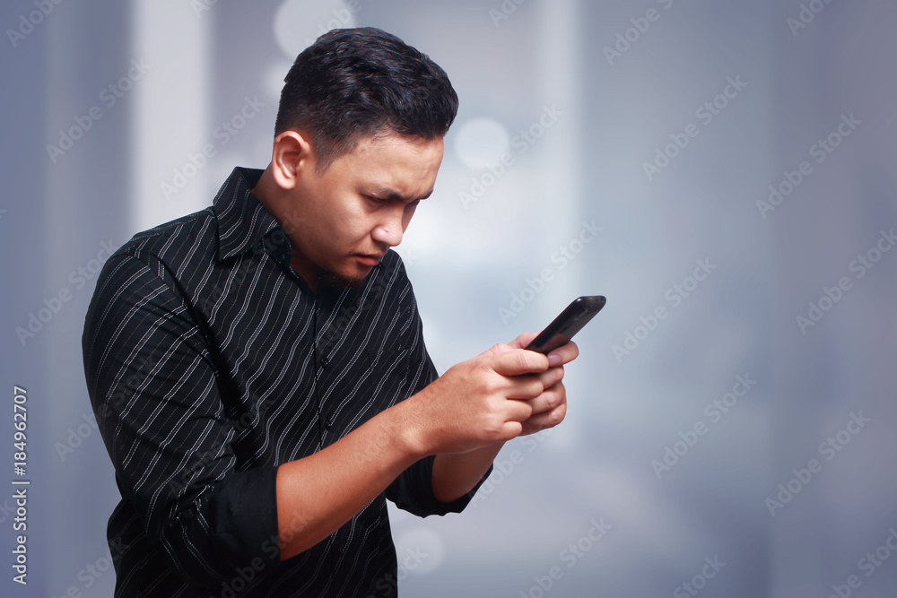 Young Man Texting Reading Chatting on His Phone Young Man Texting Reading Chatting on His Phone