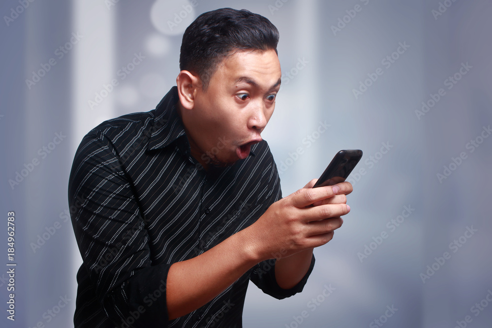 Young Man Texting Reading Chatting on His Phone, Surprised Happy Young Man Texting Reading Chatting on His Phone, Surprised Happy