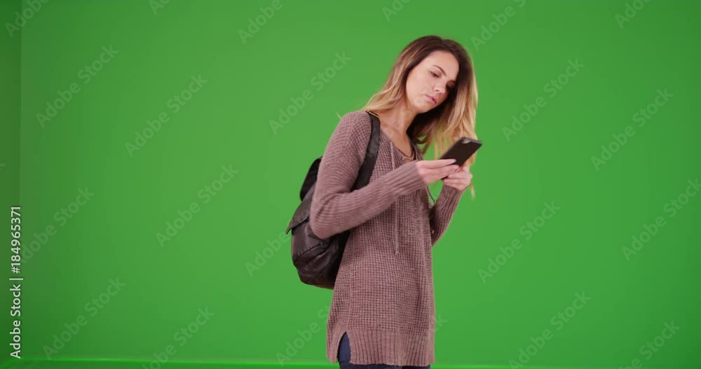 Young Caucasian woman wandering on green screen. On green screen to be keyed or composited. Young Caucasian woman wandering on green screen. On green screen to be keyed or composited.