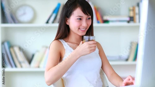 young asian woman using computer indoor