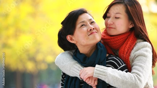 happy young asian woman with her mother  outdoor with autumn background