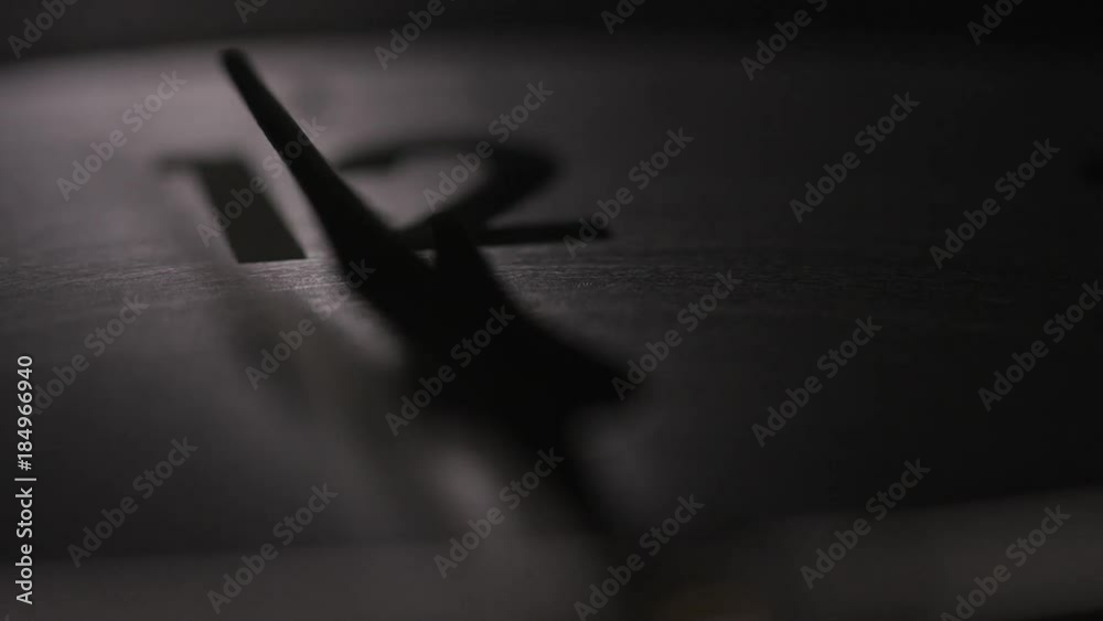 Camera moves to see clock hands ticking close to 12 o clock