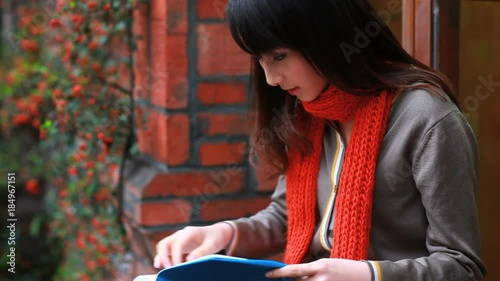 pretty college student reading book in the campus