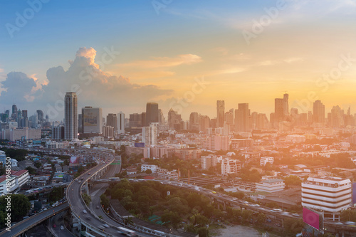 Office building and city road interchanged sunset tone, cityscape background