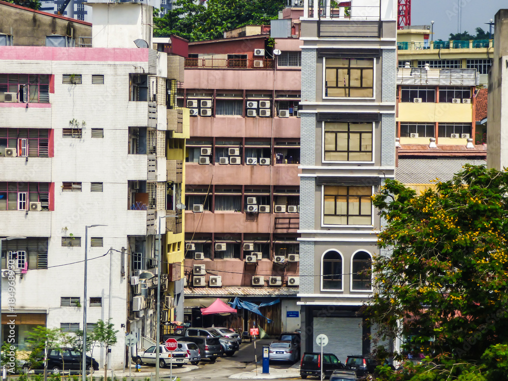 Kuala Lumpur, Malaysia - Circa October 2017: A view of the street and old apartment buildings with many air conditioners in Kuala Lumpur