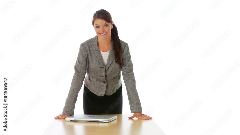 Businesswoman standing at the end of a table