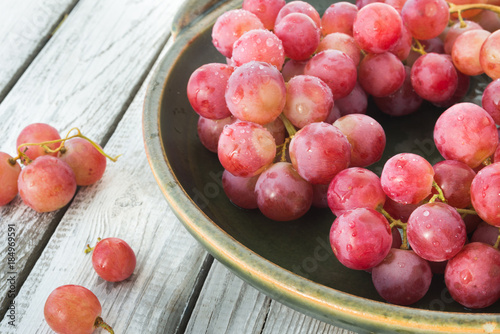 A plate of pink wet grapes