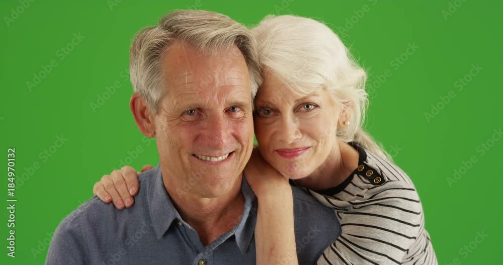 Senior couple smiling at camera on green screen. On green screen to be keyed or composited. Senior couple smiling at camera on green screen. On green screen to be keyed or composited.