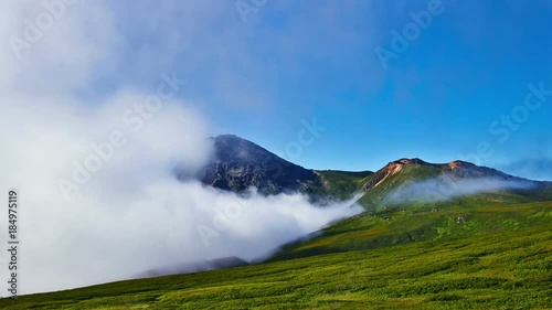 Kuril islads. Onecotan. Summer landscape with white cloud, fog and old vulkane. photo