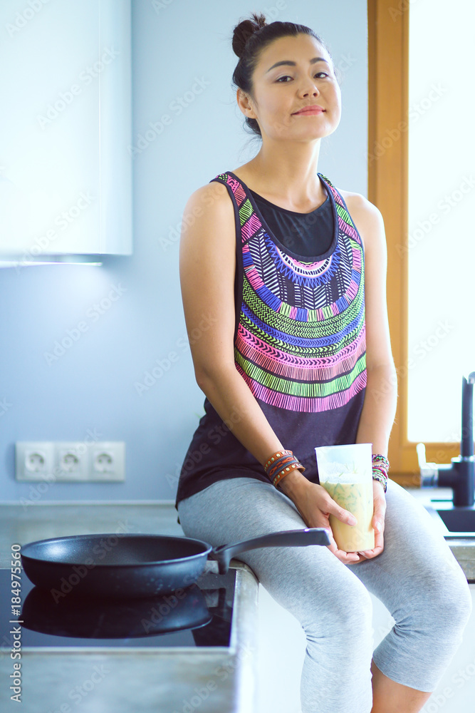 Fitness girl cooking healthy food in the kitchen. Woman. Kitchen. Cooking Fitness girl cooking healthy food in the kitchen. Woman. Kitchen. Cooking