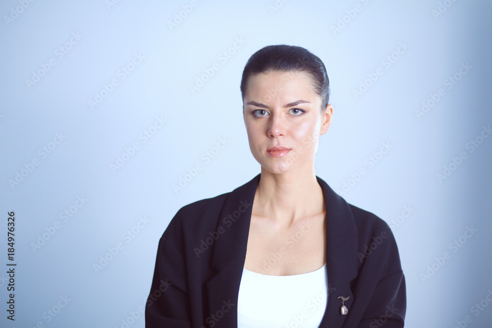 Young woman standing, isolated on gray background Young woman standing, isolated on gray background